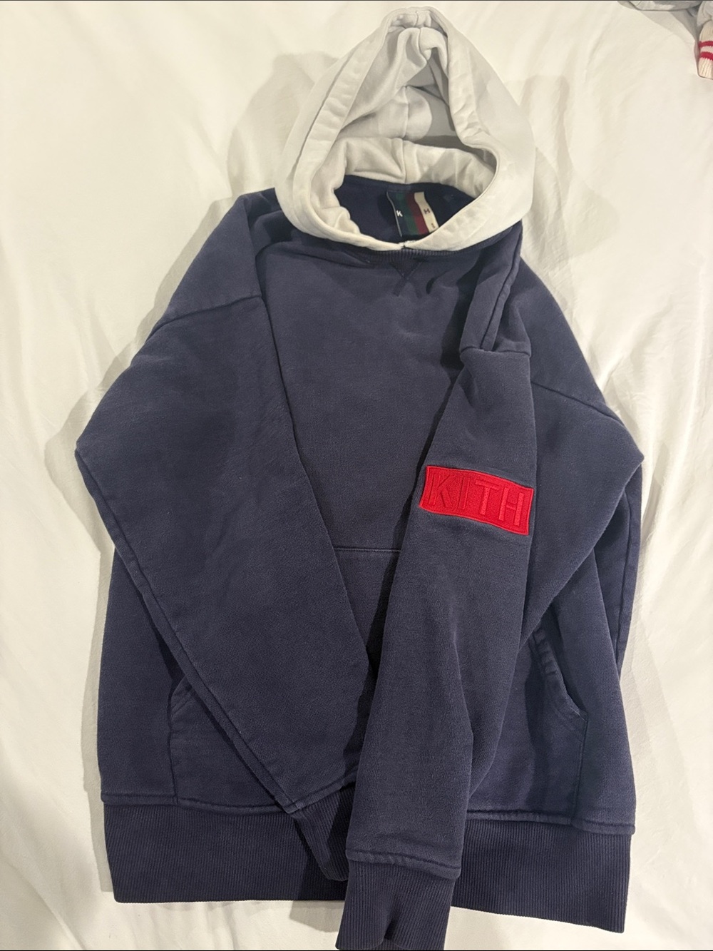Kith Navy Pullover Hoodie with White Hood and Red Sleeve Patch